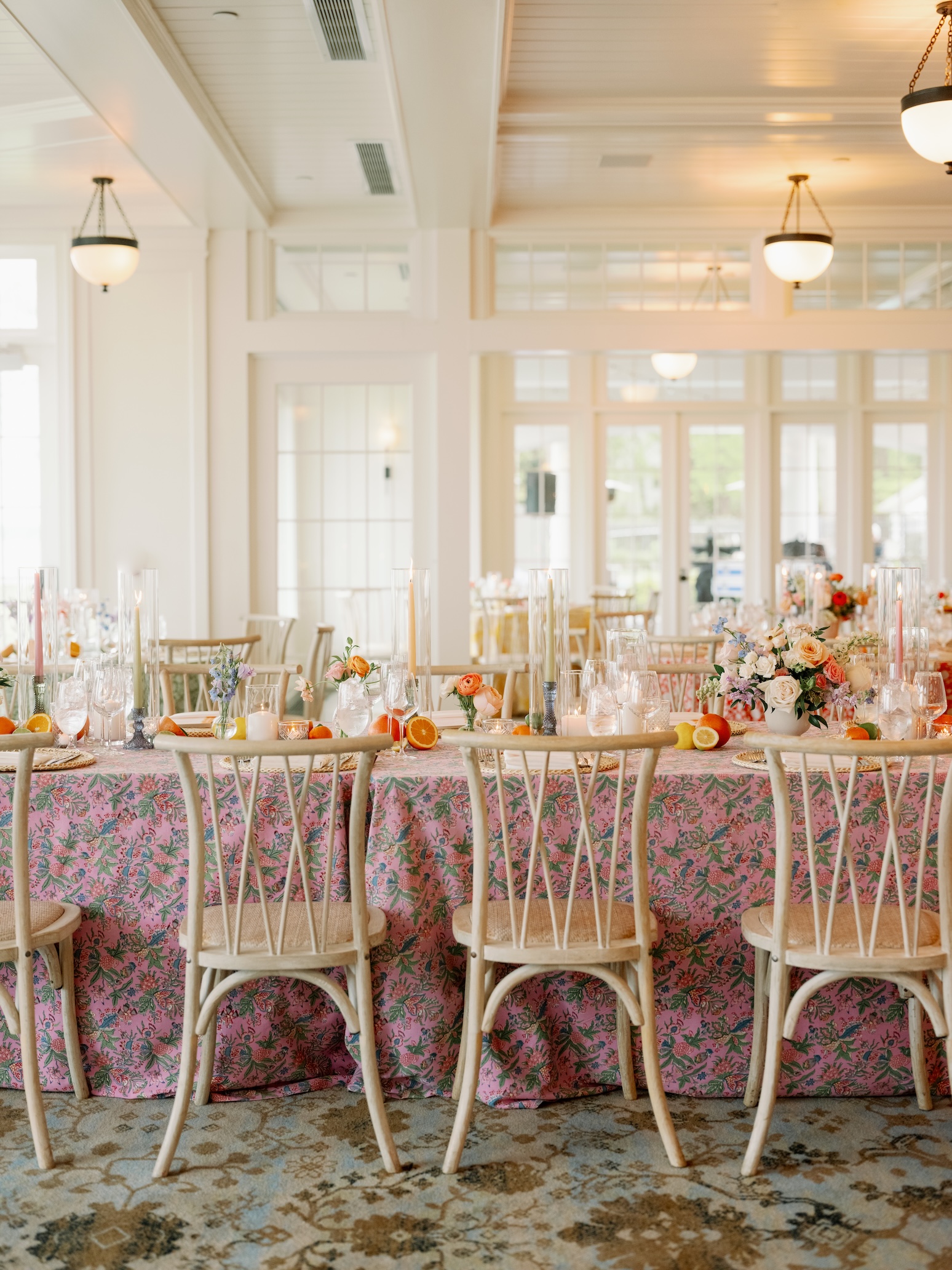 Wedding Table with wooden crossback chairs, light blue tablecloth and hydrangea florals.